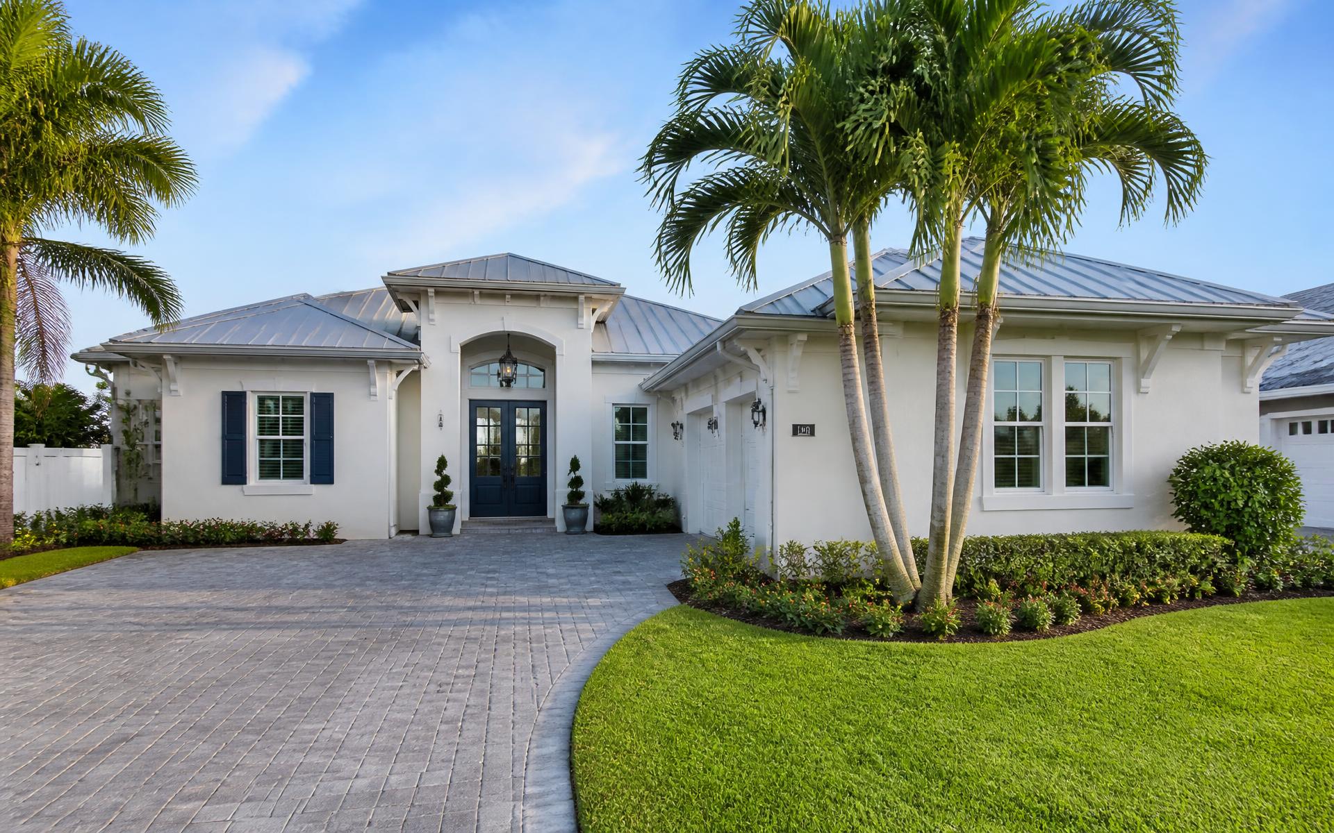 Freshly painted Florida home exterior with navy front door and crisp white trim